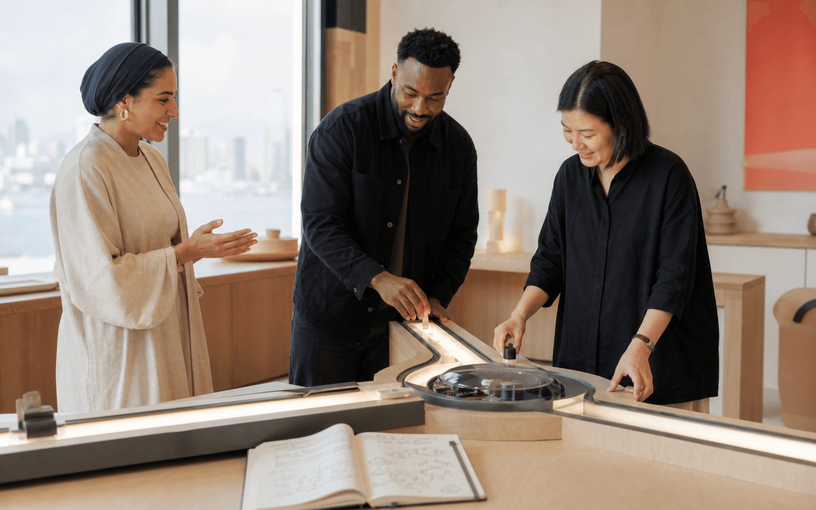 A Middle Eastern educator and Black and East Asian adult learners make meaningful choices at a branching project station while reviewing visible progress evidence